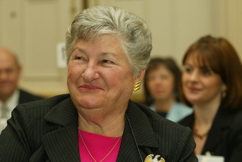 Ruth Ann Minner wearing a suit and tie smiling and looking at the camera