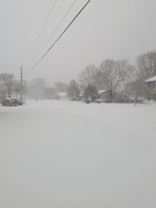 Major snowstorm kicks off 2022 23 a man standing on top of a snow covered field