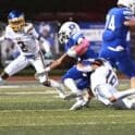 Sussex Central linebacker Justin Negron tackles Dover running back John Parker photo courtesy of Ben Fulton