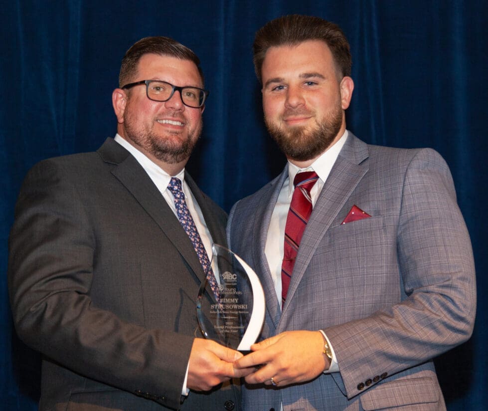Jimmy Strusowski, right, accepting his award for Young Professional of the Year.