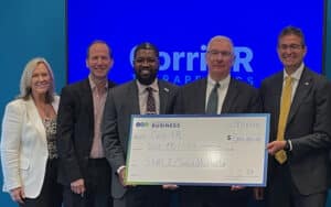 Governor Matt Meyer and Delaware Division of Small Business Director CJ Bell present a $1 million investment check to CorriXR Therapeutics. (Photo courtesy CorriXR Therapeutics)