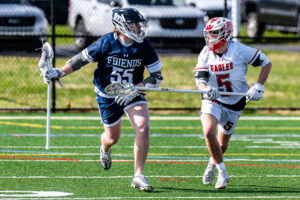 Photo Gallery: Smyrna vs Friends Boys Lacrosse 3 Wilmington Friends sophomore Evan Van Sickle (55) works to get around Smyrna defenseman junior Maximus Justice (5)
