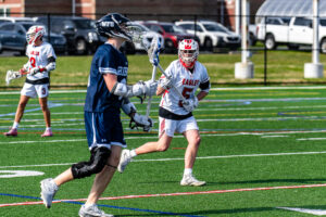 Photo Gallery: Smyrna vs Friends Boys Lacrosse 7 Friends senior Rhys Butler (8) passes the ball as Smyrna defender Maximus Justice(5) looks on.