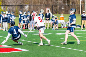 Photo Gallery: Smyrna vs Friends Boys Lacrosse 10 Smyrna's Maximus Justice (5) brings the ball up field and checks Friends Benjamin Osbourn (4)