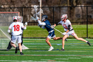 Photo Gallery: Smyrna vs Friends Boys Lacrosse 12 Smyrna defenders Jake Supinski (18) and Reed Shultz (14) converge on Friends Benjamin Osbourn (4)