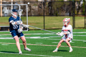 Photo Gallery: Smyrna vs Friends Boys Lacrosse 14 Friends Evan Van Sickle (55) passes the ball under pressure from Smyrna junior Michael Pierson (6)