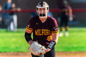 Senior Briella Salisbury looks in to her catcher for the sign on what pitch to throw against the Eagles' hitter.