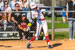 Freshman Lily Dixon just gets a piece of this pitch as the Smyrna crowd looks on.