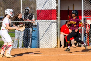 Milford senior Rihanna Adams rushes to the plate before the Smyrna catcher can receive the throw.