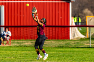 Senior Adrionna Fountain tracks the ball through the grass to make the catch for Milford.