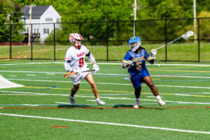 Sussex Central senior Jaden Nock looks for a passing lane as Smyrna junior Drew Marks defends.