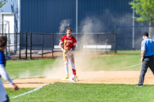 A Smyrna player celebrates after sliding into third.