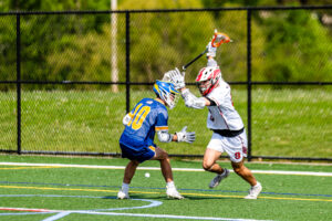 Marks attempts to get around Golden Knight senior Peyton Conaway.