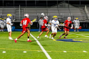 Three Smyrna defenders converge on Rider senior Sincere Lewis trying to get the ball in the offensive zone.