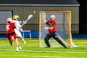 Smyrna junior Boe Evans tries to save the close shot from Caesar Rodney.