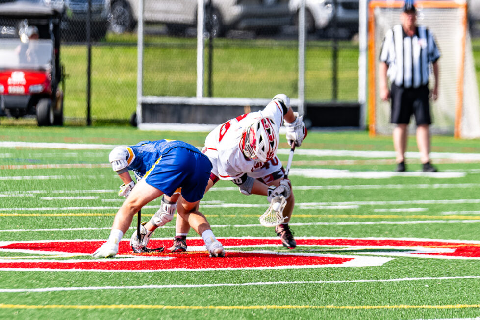 Smyrna junior Elijah Mann wins the faceoff for the Eagles.