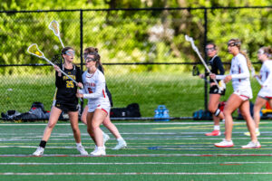 Padua Freshman Grace Spinelli looking for a teammate to pass to while being defended by Smyrna Freshman Morgan Oakley.