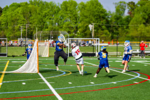 Smyrna freshman Aiden McLaughlin shoots toward the top right of the cage from close range.