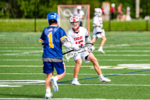 Sussex Central sophomore William Laird works on getting the ball into the offensive zone while being defended by freshman Aiden McLaughlin.