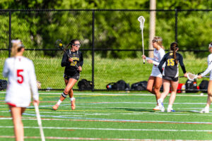 Riley Bransfield looks for a shot opportunity at the left of the cage. Bransfield scored twice in the game.