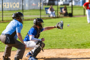 Perkins behind the plate receiving the pitch from the Senator pitcher.