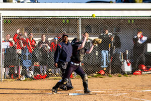 Panther catcher Gabrielle Bogdon concentrates on making the catch behind the plate.