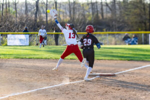 Smyrna first baseman Lindsey Roscoe stretches to make the play before Polytech sophomore Mikala Finazzo reaches the base.