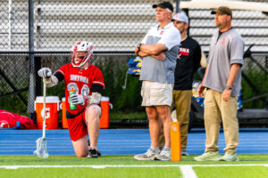 Smyrna assistant coach Jay Haller stands near the pylon looking at the action.