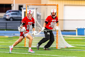 Smyrna sophomore Andrew Sharrar holds the ball trying to get it out of the Smyrna defensive end.