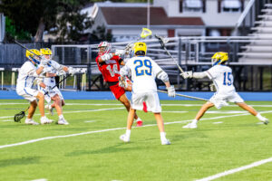 Smyrna senior Michael Sebastian shoots through a crowd of Caesar Rodney defenders.