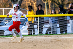 Smyrna senior Lindsey Roscoe runs the bases while watching the play unfold.