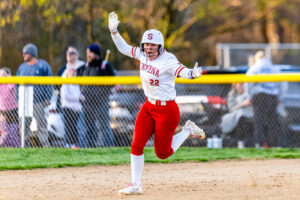 Smyrna senior Adison Weisenberger celebrates her home run as she circles the base paths.