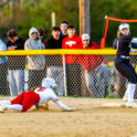 Smyrna senior Alyssa Spicer dives into the base as fans look on over the fence.