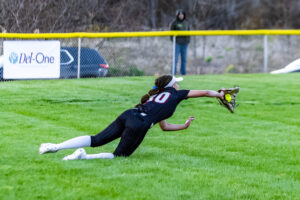Emma Shleton makes a diving catch in the outfield for Polytech.