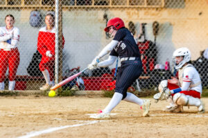 Polytech sophomore Danica Humphries reaches out to make contact with the pitch. The Panthers had 28 hits in the game.