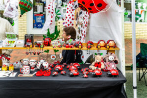 A local vendor with ladybug inspired items for sale.