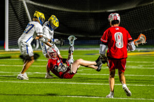 Smyrna junior Grayson Judy tries to make a pass despite being on the ground.