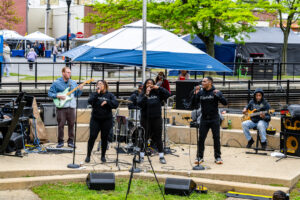 The Fuzaholics perform on stage for festival goers.