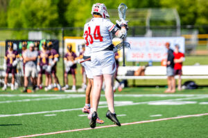 Judy celebrates his goal with a teammate. The Eagles scored 11 goals in the first half.