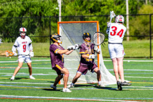 Smyrna junior Grayson Judy leaps into the air to get his shot off against the Milford defense.
