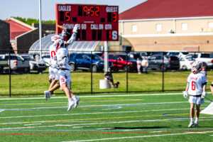 McLaughlin celebrates with his teammate, following a Smyrna score. The Eagles led, 5-3, after the first quarter.