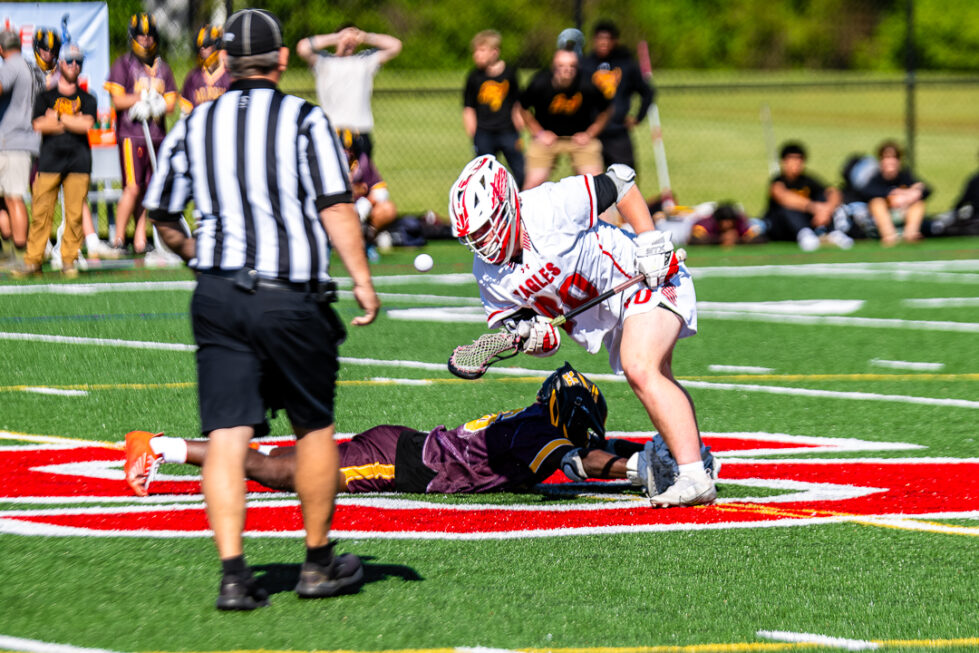 The Smyrna face-off man wins the battle and gains possession for the Eagles.