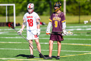 Smyrna senior Jake Supinski (18) and Milford senior Chase Reisinger (9) standing ready as the second half begins.