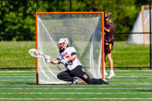 Smyrna junior Boe Evans dives to the ground to make the save.