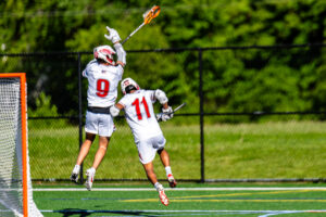 Marks (9) celebrates a Smyrna score with his teammate Braeden Marshall (11).