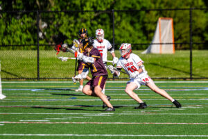 Reisinger (9) attempts to get around Supinski (18) on the offensive end.
